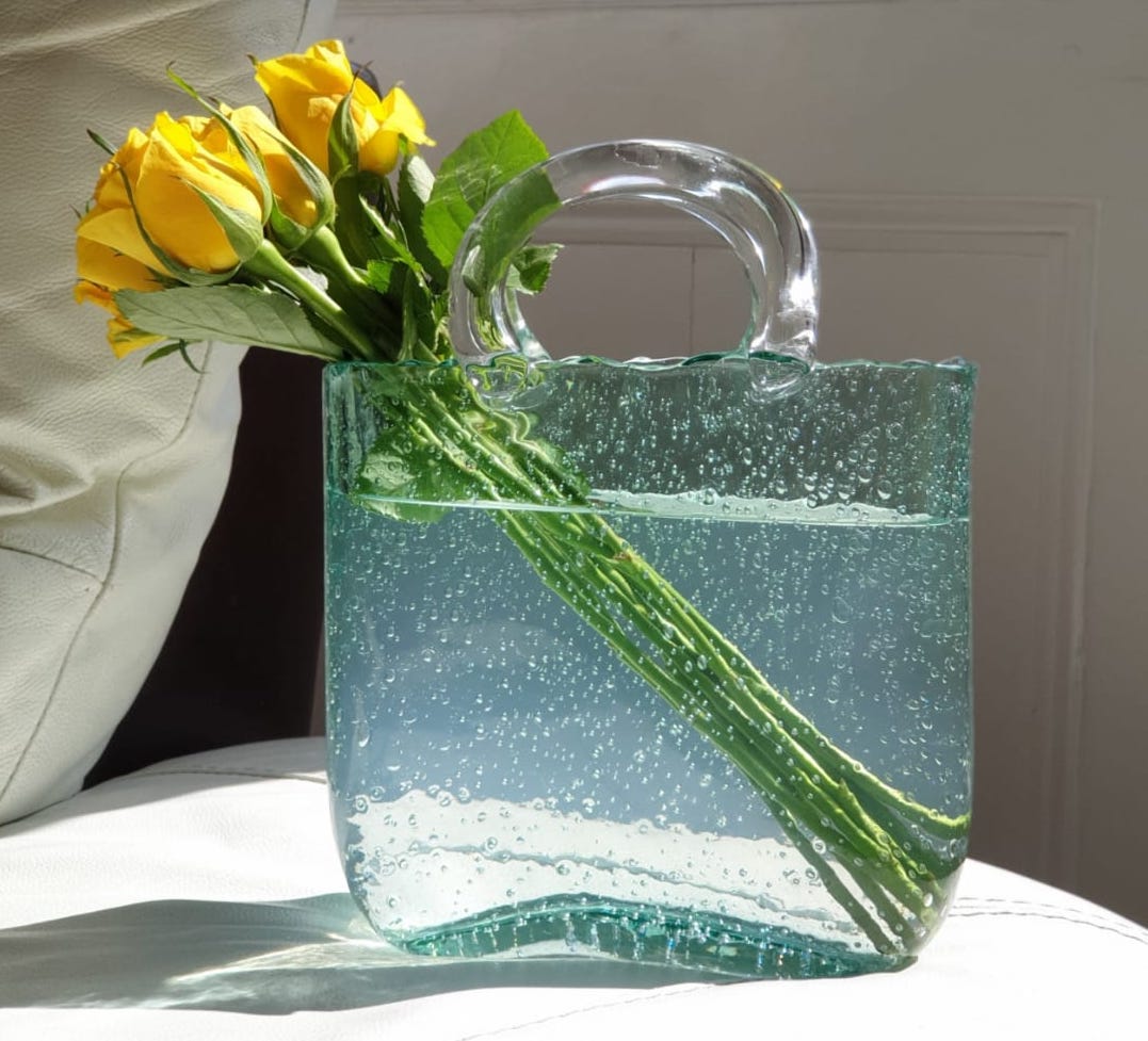 One low vessel, a few stems from the garden — a centrepiece nobody has to talk around.